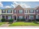 Charming townhome featuring brick facade, black shutters, and well-maintained landscaping at 4544 Parkview Sq, Atlanta, GA 30349
