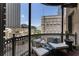 Relaxing balcony with lounge chairs, pillows, and city skyline views at 75 Ponce De Leon Ave # 701, Atlanta, GA 30308