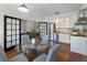 Open dining area with hardwood floors, modern lighting, and seating for four at 75 Ponce De Leon Ave # 701, Atlanta, GA 30308