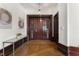 Elegant entryway featuring hardwood floors, paneled walls, and a console table with decorative items at 75 Ponce De Leon Ave # 701, Atlanta, GA 30308