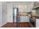 Modern kitchen with stainless steel appliances, white cabinets, and hardwood floors at 75 Ponce De Leon Ave # 701, Atlanta, GA 30308