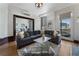 Comfortable living room with large windows offering city views, open to the dining area, and a fireplace at 75 Ponce De Leon Ave # 701, Atlanta, GA 30308
