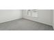 Well-lit bedroom features plush gray carpet and a large window at 7760 Sheffield Ter, Fairburn, GA 30213