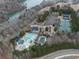 Aerial view showcases community amenities including swimming pools, tennis courts, and lake access at 106 Twilight Overlook, Canton, GA 30114