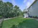 Expansive backyard featuring a multi-level deck, lush green lawn, and mature trees at 106 Twilight Overlook, Canton, GA 30114