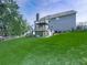 Spacious backyard showcasing a lush green lawn, a multi-level deck, and mature trees at 106 Twilight Overlook, Canton, GA 30114