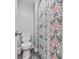 Powder room with a toilet and decorative shower curtain in a well lit bathroom at 106 Twilight Overlook, Canton, GA 30114