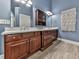 Elegant bathroom with cherry wood vanities, double sinks, and stylish tiled flooring at 106 Twilight Overlook, Canton, GA 30114