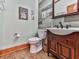 Cozy half-bathroom features wood accent wall, wood-look floors, and vintage-style sink at 106 Twilight Overlook, Canton, GA 30114