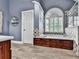 Inviting bathroom featuring a large soaking tub with tile surround and arched window at 106 Twilight Overlook, Canton, GA 30114