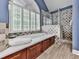 Luxurious bathroom showcasing a soaking tub, tiled shower, and elegant shuttered window at 106 Twilight Overlook, Canton, GA 30114