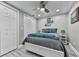 Cozy bedroom featuring a ceiling fan, gray walls and flooring, and two closet doors at 106 Twilight Overlook, Canton, GA 30114