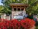 Charming stone community entrance with a covered area, featuring the 'Great Sky' sign amidst vibrant landscaping at 106 Twilight Overlook, Canton, GA 30114