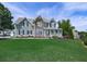 Two-story home boasting stone accents and a lush green lawn, enhanced by mature trees and meticulous landscaping at 106 Twilight Overlook, Canton, GA 30114