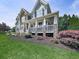 Charming two-story home with a welcoming front porch, stone accents, and beautifully landscaped front yard at 106 Twilight Overlook, Canton, GA 30114