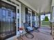 Inviting front porch featuring dark-stained door, neutral siding, and cozy seating with decorative pillows at 106 Twilight Overlook, Canton, GA 30114