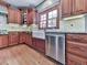 Charming kitchen features a farmhouse sink, stainless steel dishwasher, and wooden cabinetry at 106 Twilight Overlook, Canton, GA 30114