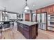 Open kitchen featuring stainless steel appliances, center island, and wood floors at 106 Twilight Overlook, Canton, GA 30114