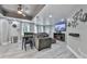 Modern living room with a ceiling fan, gray walls, and updated flooring and finishes at 106 Twilight Overlook, Canton, GA 30114