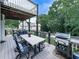 Outdoor patio area with a dining set, grill, and ample space for outdoor activities at 106 Twilight Overlook, Canton, GA 30114