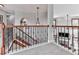 View of staircase with decorative iron railings, hardwood steps, and neutral carpeted landing at 106 Twilight Overlook, Canton, GA 30114