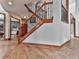 Elegant staircase featuring hardwood steps, iron spindles, and an open floor plan at 106 Twilight Overlook, Canton, GA 30114