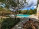 Large community swimming pool surrounded by trees, landscaping, and a concrete deck at 106 Twilight Overlook, Canton, GA 30114
