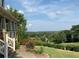 Picturesque view of landscaped yard with vibrant flowers and tree-lined horizon at 106 Twilight Overlook, Canton, GA 30114