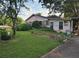 Modest one-story home featuring a spacious front lawn and mature trees at 3838 Dunbury Ln, Decatur, GA 30032