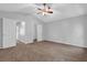 Bedroom with plush carpeting, a ceiling fan, and bright natural light at 6541 Lazy Creek Ct, Lithonia, GA 30058