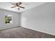 Serene bedroom featuring neutral walls, ample natural light, and plush brown carpeting at 6541 Lazy Creek Ct, Lithonia, GA 30058