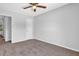 Clean bedroom featuring neutral walls, carpet, and a ceiling fan for added comfort at 6541 Lazy Creek Ct, Lithonia, GA 30058