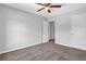 Neutral bedroom with a ceiling fan and carpet flooring, complemented by white trim and doors at 6541 Lazy Creek Ct, Lithonia, GA 30058