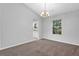 Dining room with light-filled windows, neutral walls, and views into the kitchen at 6541 Lazy Creek Ct, Lithonia, GA 30058