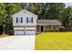 Charming two-story home with attached two-car garage and well-manicured lawn and black window shutters at 6541 Lazy Creek Ct, Lithonia, GA 30058