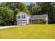 Inviting two-story home featuring a well-kept front lawn, two-car garage, and classic design at 6541 Lazy Creek Ct, Lithonia, GA 30058