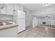 Open concept kitchen with stainless steel appliances and view of the staircase at 6541 Lazy Creek Ct, Lithonia, GA 30058