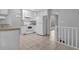 Bright kitchen featuring white cabinets and appliances and tile flooring at 6541 Lazy Creek Ct, Lithonia, GA 30058