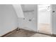 A utility room with gray walls, a wire rack, and hookups for a washer and dryer next to a bedroom at 6541 Lazy Creek Ct, Lithonia, GA 30058