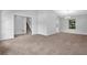 Open-concept living room with neutral paint, staircase access and plush brown carpeting at 6541 Lazy Creek Ct, Lithonia, GA 30058