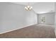 Bright living room with vaulted ceiling, carpet, and large window at 6541 Lazy Creek Ct, Lithonia, GA 30058