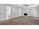Comfortable living room featuring a fireplace, neutral walls, and plush brown carpeting at 6541 Lazy Creek Ct, Lithonia, GA 30058