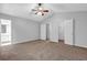Spacious main bedroom featuring carpet, neutral walls, and a ceiling fan for added comfort at 6541 Lazy Creek Ct, Lithonia, GA 30058