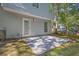 Concrete patio area with access to the home, adjacent to lawn and mature trees at 6541 Lazy Creek Ct, Lithonia, GA 30058