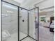 Modern bathroom featuring a frameless glass shower, marble tile, and bench seat at 99 Silver Leaf Trce, Douglasville, GA 30134