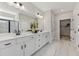 Bright bathroom boasts a double sink vanity with sleek fixtures and a glass-enclosed shower at 99 Silver Leaf Trce, Douglasville, GA 30134