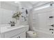 Bright bathroom featuring a single vanity, a soaking tub, and a shower with a shower curtain at 99 Silver Leaf Trce, Douglasville, GA 30134