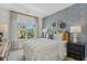 Stylishly decorated bedroom with a blue accent wall, a queen bed, and ample natural light at 99 Silver Leaf Trce, Douglasville, GA 30134