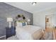 Well-appointed bedroom featuring a blue wallpaper accent wall, modern decor, and comfortable furnishings at 99 Silver Leaf Trce, Douglasville, GA 30134