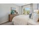 Cozy bedroom featuring a dresser with drawers, stylish lamps, artwork, and a window view at 99 Silver Leaf Trce, Douglasville, GA 30134